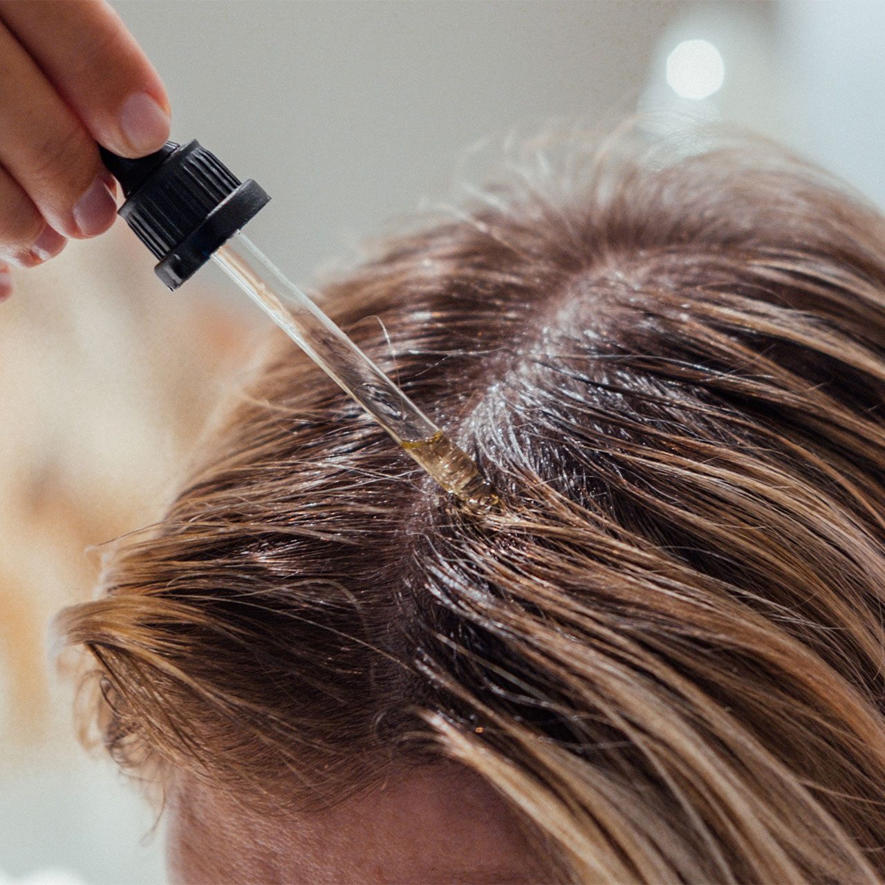 woman-applying-hair-oil-to-scalp-1.jpg